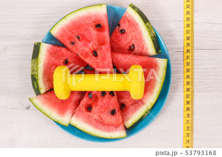 Tape measure, dumbbells and watermelon Tape measure, dumbbells and watermelon 53793168
