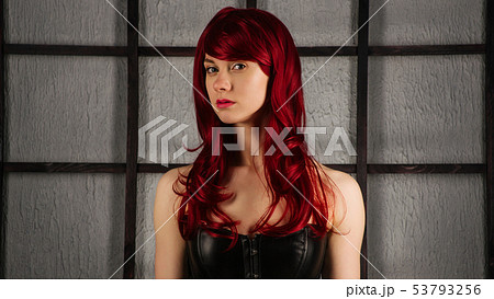 Portrait of Red-haired girl in a leather corset 53793256