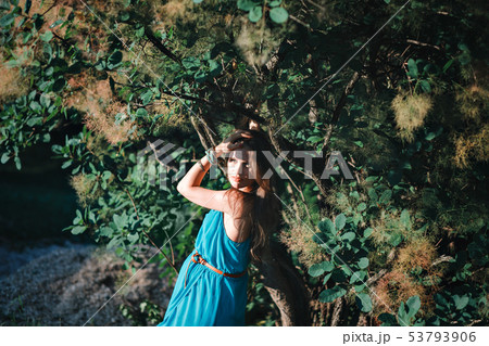 Young pregnant woman in the park outdoors. Calm pregnant woman in third trimester. Walking in public 53793906