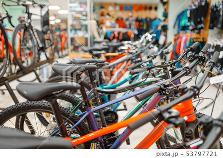 Rows of bicycles in sports shop, focus on seat 53797721