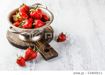 Fresh strawberries in a while colander Fresh strawberries in a while colander 53800011