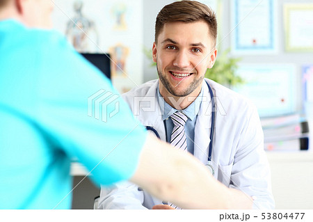 Smiling doctor posing in hospital office Smiling doctor posing in hospital office 53804477