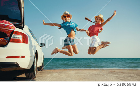 happy children girls twin sisters on car ride to 53806942