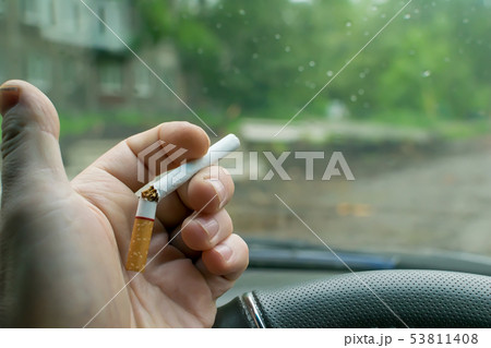hand man holding a broken cigarette 53811408