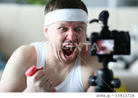 Screaming Man Holding Dumbbell Record on Camera Screaming Man Holding Dumbbell Record on Camera 53813716