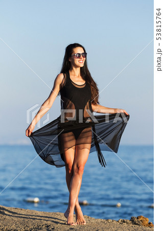 pretty woman dancing near an ocean 53815764