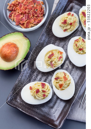 Deviled eggs stuffed with avocado, egg yolk  53822203