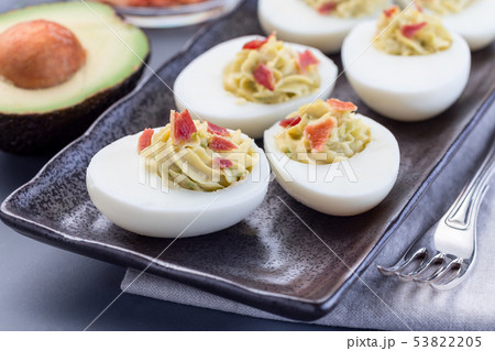 Deviled eggs stuffed with avocado, egg yolk 53822205