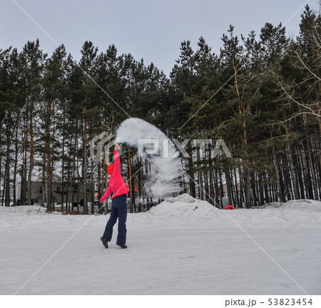A tourist throwing hot water  at winter park 53823454