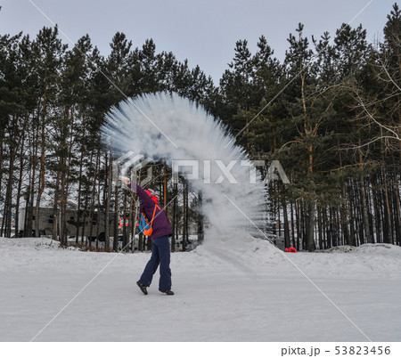 A tourist throwing hot water  at winter park 53823456