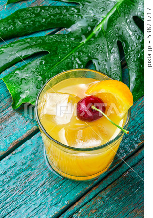 Orange drink with cherry 53823717