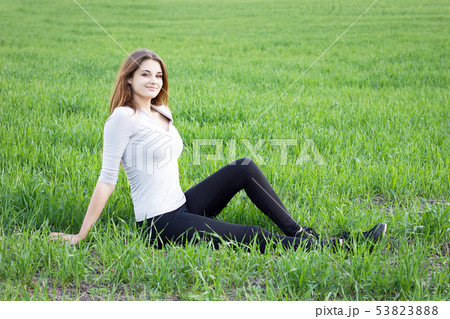 girl resting on the green field. Camping 53823888