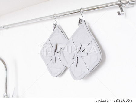 Kitchen potholder on a white brick wall background 53826955