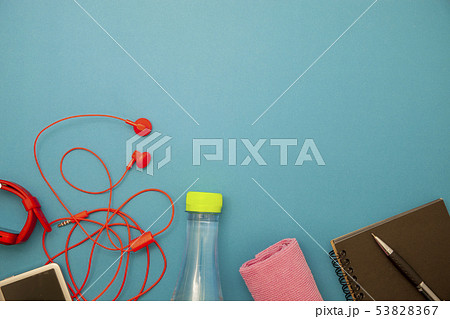 Close up of water bottle,watch and red earphones Close up of water bottle,watch and red earphones 53828367