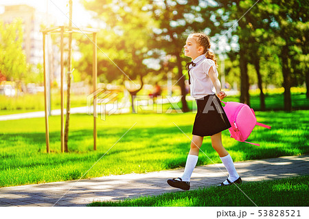 Portrait of happy Caucasian young smiling girl wearing school backpack outside the primary school Portrait of happy Caucasian young smiling girl wearing school backpack outside the primary school 53828521