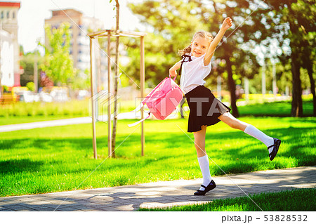 Portrait of happy Caucasian young smiling girl wearing school backpack outside the primary school Portrait of happy Caucasian young smiling girl wearing school backpack outside the primary school 53828532