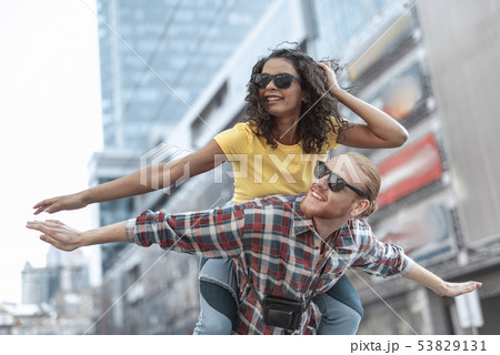 Jolly young couple is having nice time in city Jolly young couple is having nice time in city 53829131