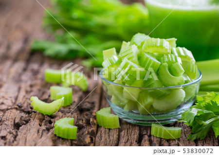 Fresh sliced green celery in glass on wood Fresh sliced green celery in glass on wood 53830072