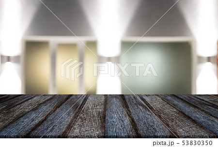 Selective Empty wooden table in front of abstract 53830350