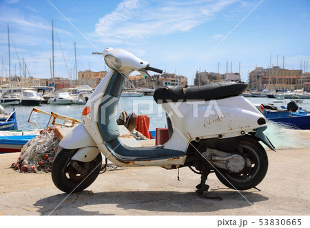 Old Italian scooter on the city pier 53830665
