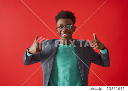 Happy young guy posing and looking at camera Happy young guy posing and looking at camera 53831053