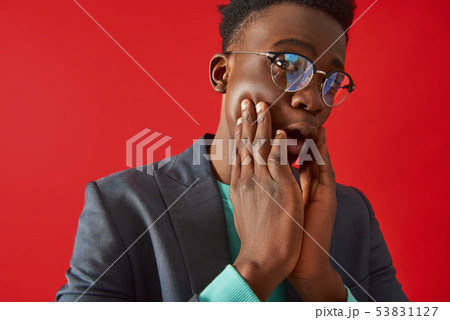 Afro American guy is covering face with hands Afro American guy is covering face with hands 53831127