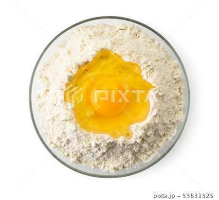 Broken egg in a plate of flour on a white. The Broken egg in a plate of flour on a white. The 53831525