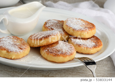 Breakfast. Cheese pancakes with sour cream Breakfast. Cheese pancakes with sour cream 53833144