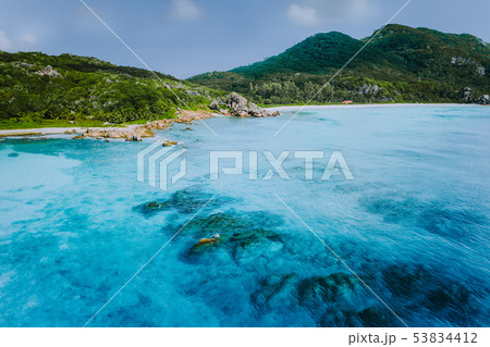 Tropical coastline of La Digue island with granite boulders and paradise beaches, view from the sea Tropical coastline of La Digue island with granite boulders and paradise beaches, view from the sea 53834412