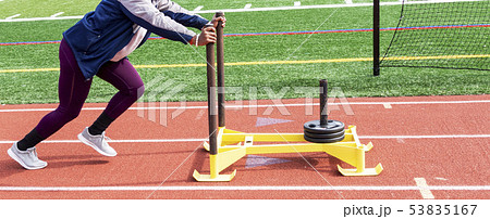 High school girl pushing sled with 75 pounds. High school girl pushing sled with 75 pounds. 53835167