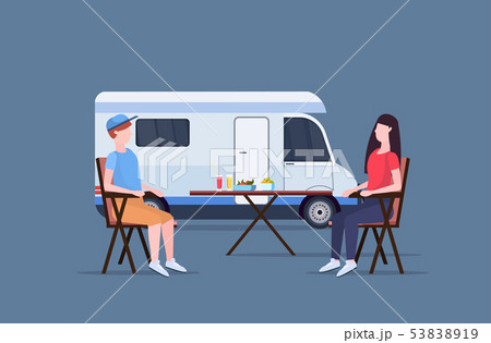 couple sitting at table near camping family trailer truck caravan car man woman spendingtime togeher couple sitting at table near camping family trailer truck caravan car man woman spendingtime togeher 53838919