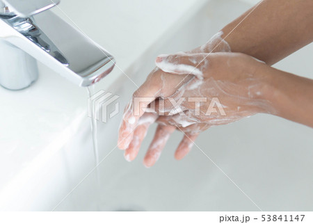 Closeup woman's hand washing with soap Closeup woman's hand washing with soap 53841147