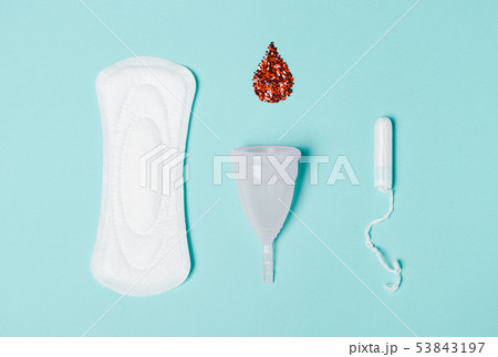Tampon, Pad, menstrual cup with a drop of blood on 53843197