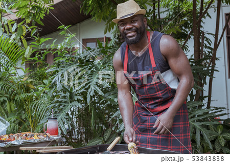 Smiling chef with barbecue dinner camping in Smiling chef with barbecue dinner camping in 53843838