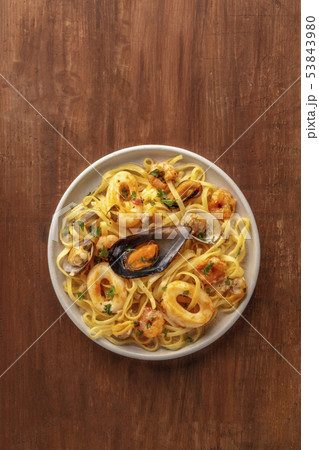 Seafood pasta. An overhead photo of a plate of tagliolini with mussels, shrimps, clams and squid Seafood pasta. An overhead photo of a plate of tagliolini with mussels, shrimps, clams and squid 53843980