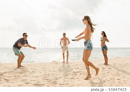 Friends playing at the beach on summer holidays 53847425