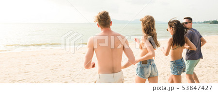 Young happy friends playing together on the beach 53847427