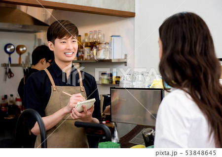 Young coffee shop owner taking order from customer 53848645