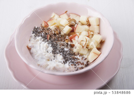 Homemade muesli with nuts and apples in a pink 53848686