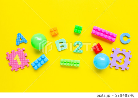 Colorful Kids toys on yellow background. Colorful Kids toys on yellow background. 53848846