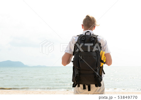 Independent backpacker standing at the beach 53849770