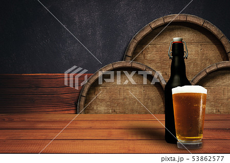 Wooden barrel background and glass of beer on a Wooden barrel background and glass of beer on a 53862577