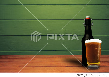 Glass of beer and black bottle beer on a red wood Glass of beer and black bottle beer on a red wood 53862620