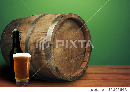 Wooden barrel, glass of beer and black bottle on a 53862648