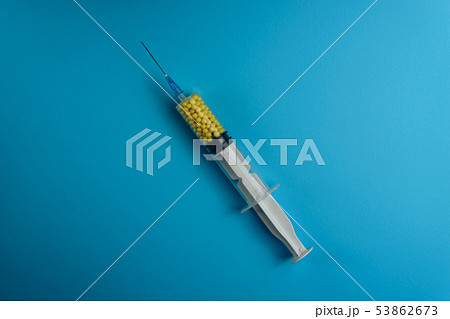 Syringe filled with colorful nano balls on a blue Syringe filled with colorful nano balls on a blue 53862673