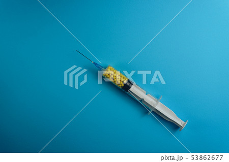 Syringe filled with colorful nano balls on a blue 53862677
