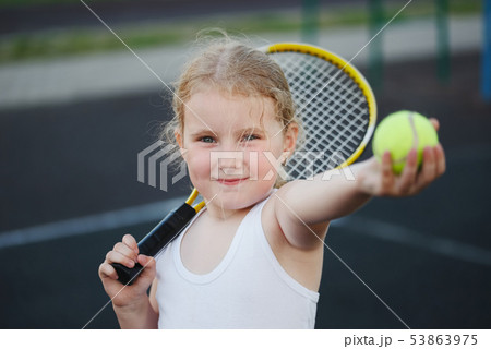 happy girl plays tennis on court outdoors happy girl plays tennis on court outdoors 53863975