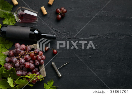 Top view of tasty fruit plate with the wine bottle on the black stone 53865704