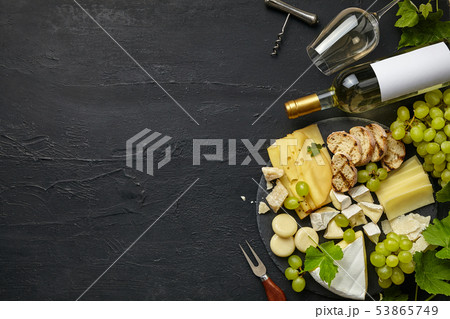 Top view of tasty cheese plate with fruit on the black stone Top view of tasty cheese plate with fruit on the black stone 53865749