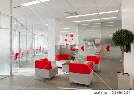 Minsk, Belarus - May 23, 2019: Corner of modern office with white walls, gray floor, open space area Minsk, Belarus - May 23, 2019: Corner of modern office with white walls, gray floor, open space area 53866134